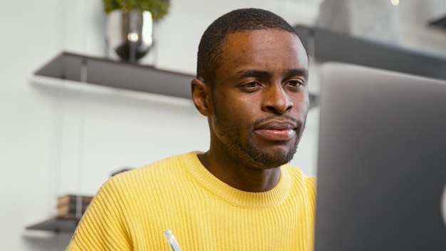 Young attractive student using laptop