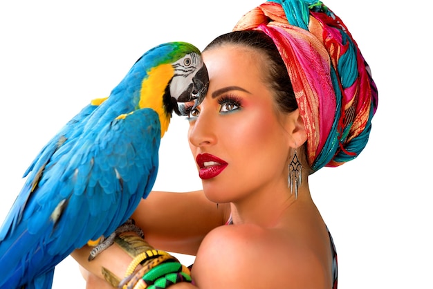 young attractive woman in african style with ara parrot on her hand on colorful background