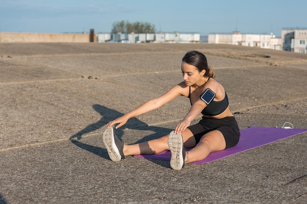 Young attractive woman doing exercise working out outdoors