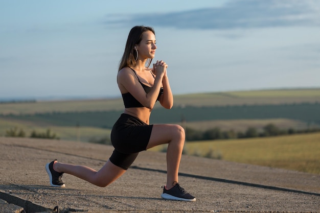 Young attractive woman doing exercise working out outdoors