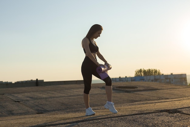 Young attractive woman doing exercise working outdoors