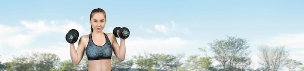 Young attractive woman doing exercise working outdoors