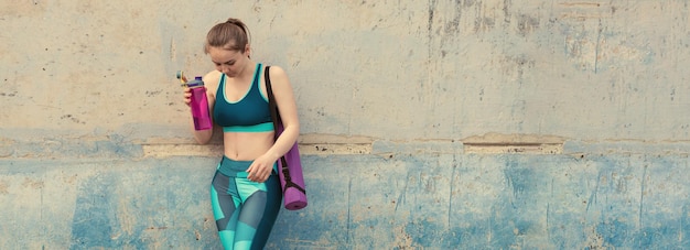 Young attractive woman doing exercise working outdoors