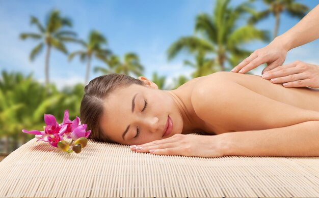 Young attractive woman getting spa treatment over white background