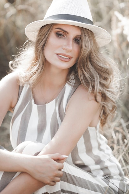 Young attractive woman in the hat Closeup portrait of beautiful woman outdoors Pretty lady smiling