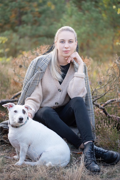 Young attractive woman playing with dog