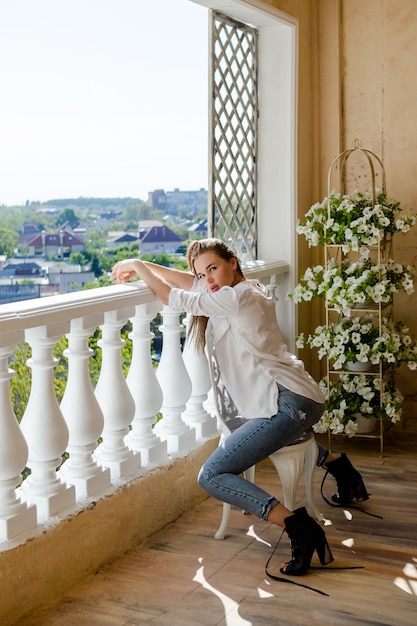 Young attractive woman sitting on terrace