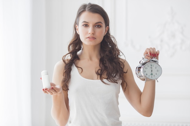 Young attractive woman taking pills at right time