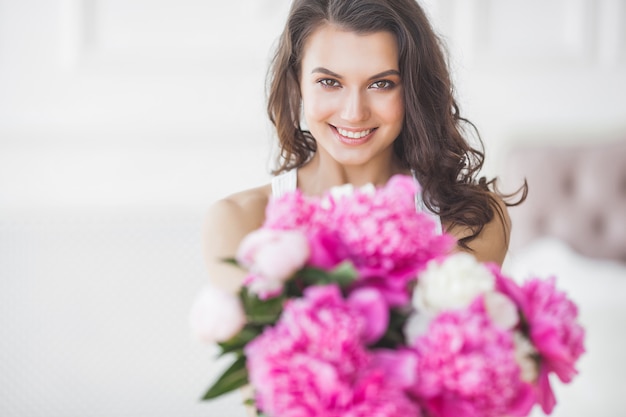 Young attractive woman with flowers