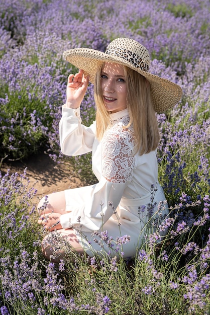 Young attractive woman in with lavender blossom