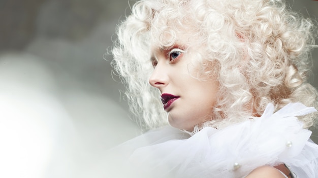 Young attractive woman with platinum blonde and purple lipstick