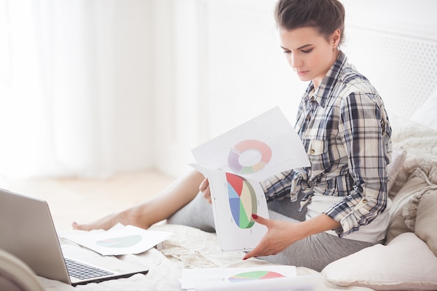 Young attractive woman working at laptop