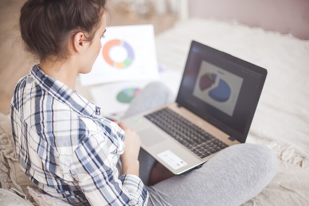 Young attractive woman working at laptop