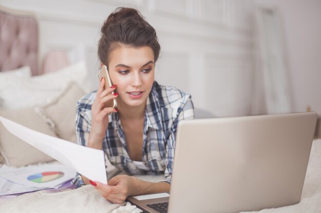 Young attractive woman working at laptop