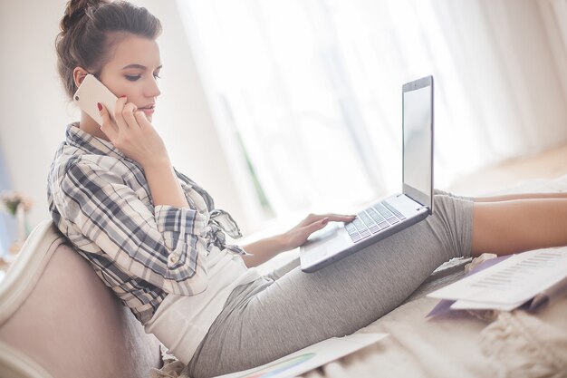 Young attractive woman working at laptop