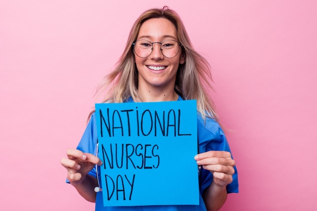 Young australian nurse woman holding a international nurses day placard isolated on blue background