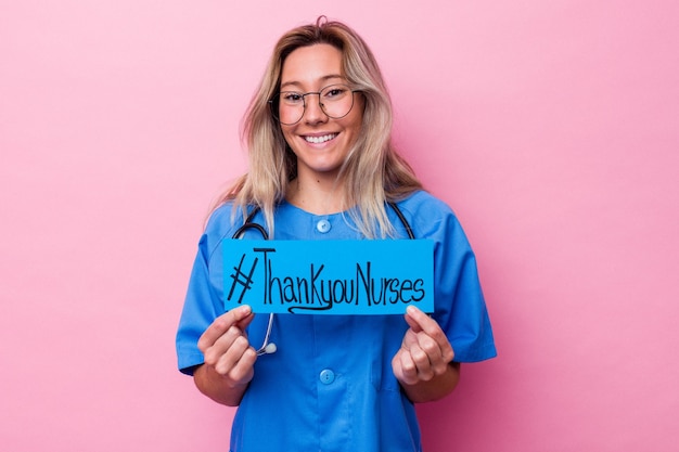 Photo young australian nurse woman holding a international nurses day placard isolated on blue background