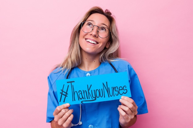 Young australian nurse woman holding a international nurses day placard isolated on blue background