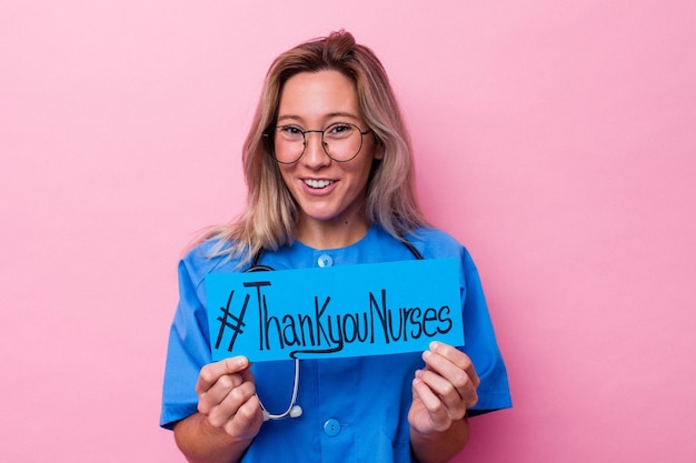 Photo young australian nurse woman holding a international nurses day placard isolated on blue background