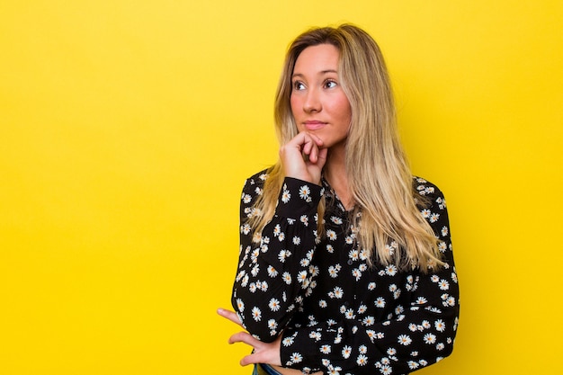 Young australian woman isolated looking sideways with doubtful and skeptical expression.