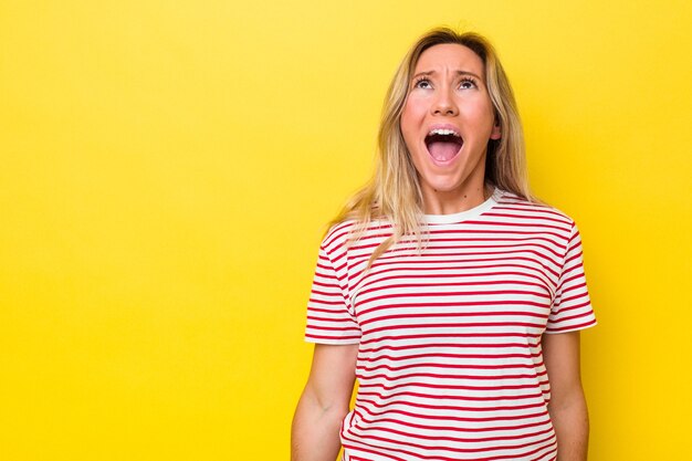 Young australian woman isolated shouting very angry, rage concept, frustrated.