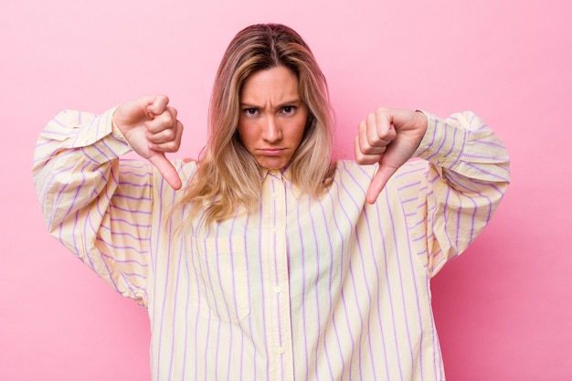 Young australian woman isolated showing a dislike gesture, thumbs down. Disagreement concept.