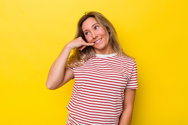 Young australian woman isolated showing a mobile phone call gesture with fingers.