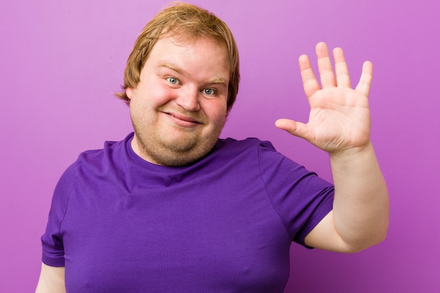 Young authentic redhead fat man smiling cheerful showing number five with fingers.