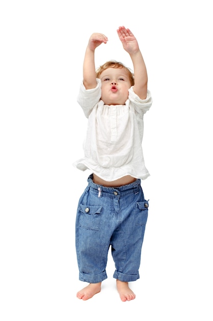 Young baby standing indoors applauding and smiling