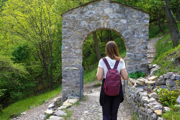 Young backpacker under an archway door