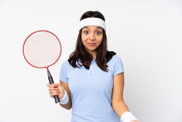 Young badminton player woman over isolated white wall smiling