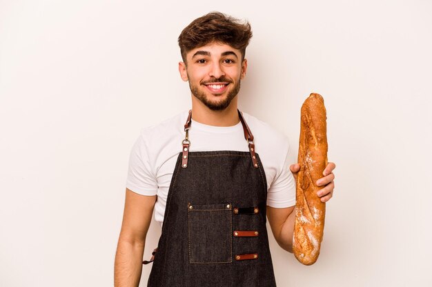 Young baker hispanic man isolated on white background happy smiling and cheerful