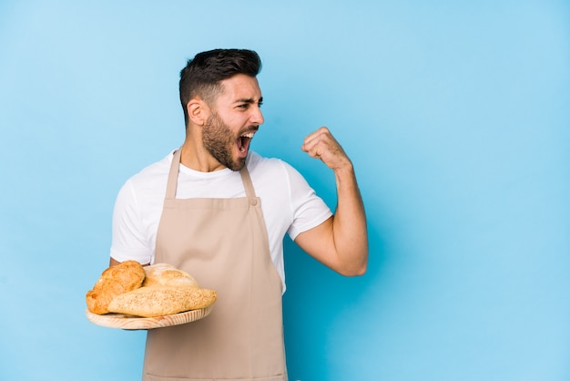 Young baker man with bread