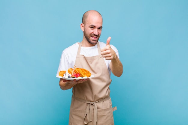 Young baker man with waffles