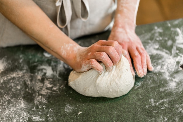 Young baker preparing artisan sourdough bread.