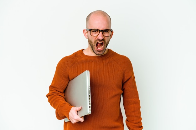 Young bald man holding a laptop isolated