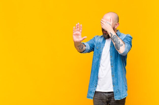 young bald man model expressing a concept 