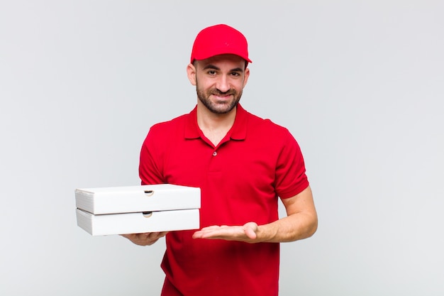 Young bald man smiling cheerfully, feeling happy