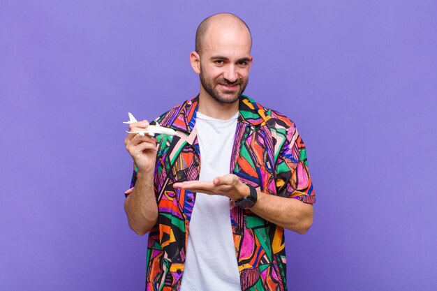 Young bald man smiling cheerfully