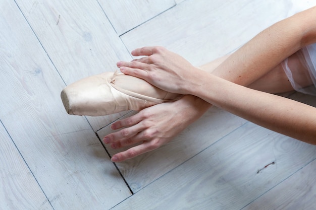 Young ballerina practicing ballet positions in studio