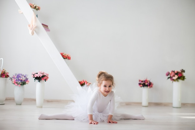 Young ballerina stretching.