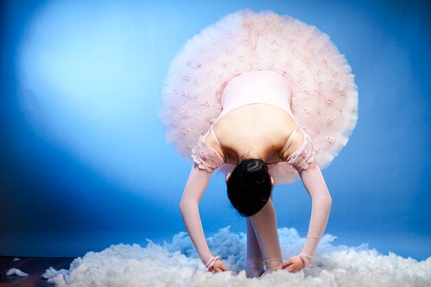 Young ballet dancer in blue studio