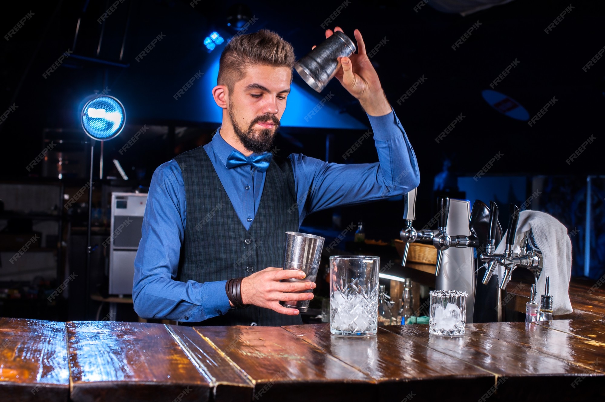Premium Photo Young barkeeper demonstrates the process of making a Premium Photo Young barkeeper demonstrates the process of making a