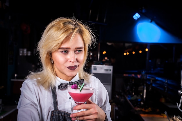 Young bartender creating a cocktail in pub