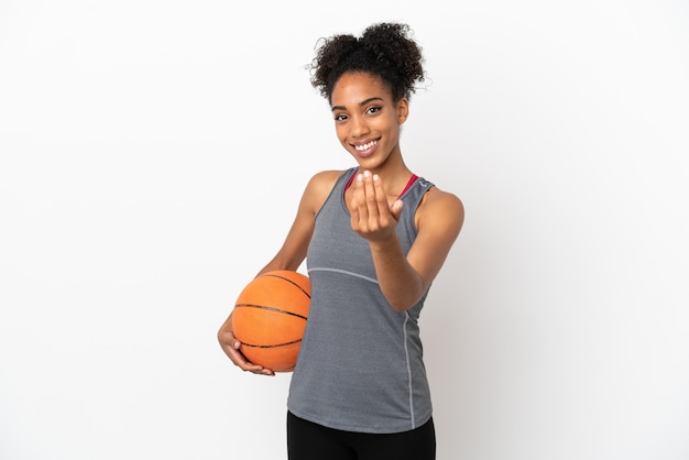 Young basketball player latin woman isolated on white background playing basketball and doing coming gesture