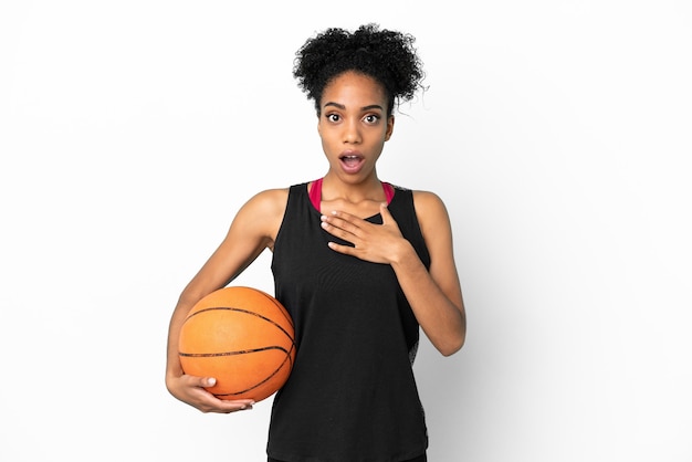 Young basketball player latin woman isolated on white background surprised and shocked while looking right