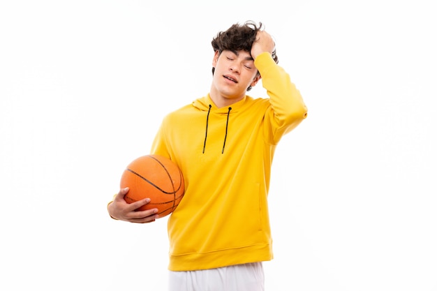 Young basketball player man over isolated white wall has realized something and intending the solution