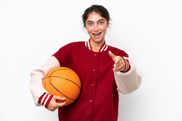 Photo young basketball player woman isolated on white background shaking hands for closing a good deal