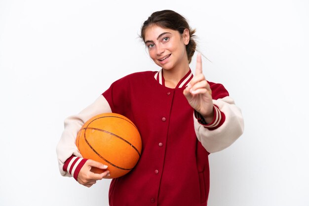 Photo young basketball player woman isolated on white background showing and lifting a finger