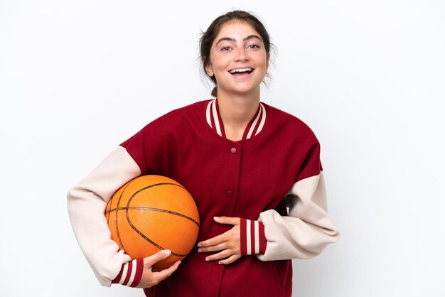 Young basketball player woman isolated on white background smiling a lot